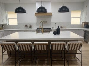 A dining table in a kitchen with white interiors.