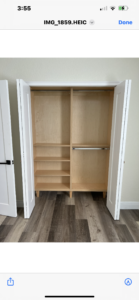 An empty wooden cabinet with an open door