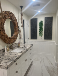 A round mirror in a washing room with white interiors