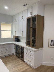 White kitchen cabinets with glass doors.