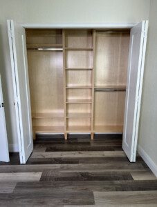 Empty closet with shelves and hanging rod.